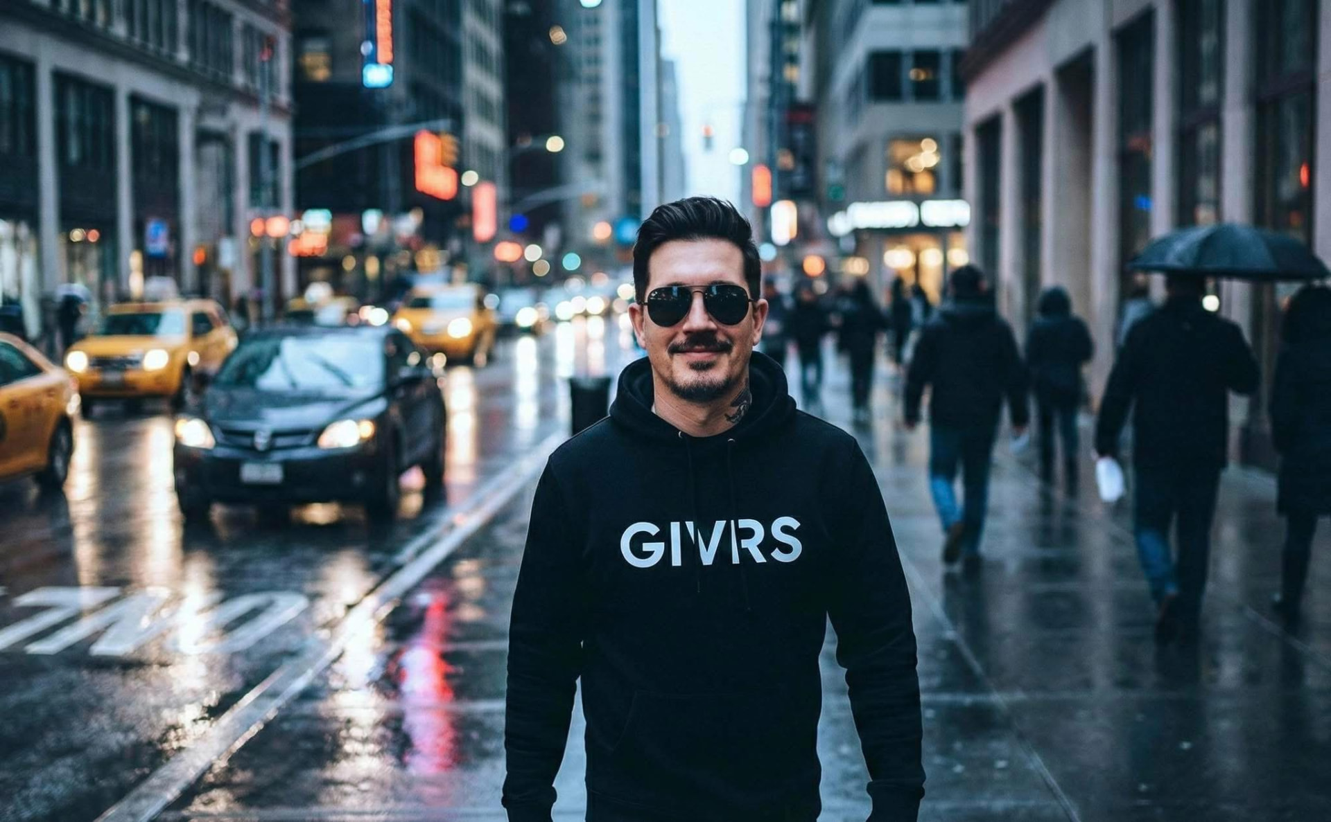Christopher Kennedy, founder of GIVRS, on a city street in a GIVRS hoodie